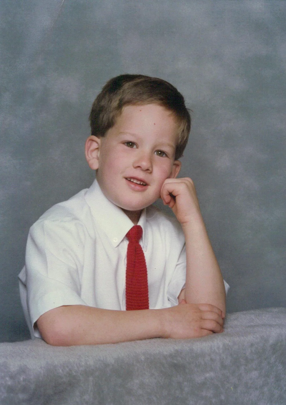Jeremy as a child in a shirt and tie