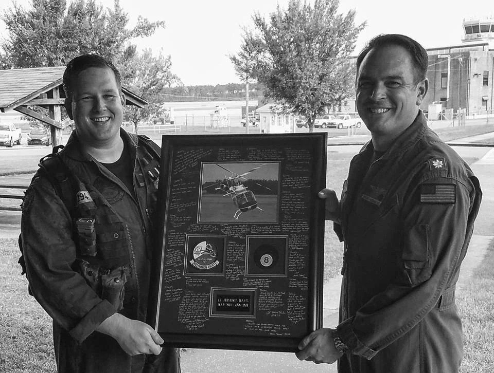 Jeremy receiving a military photo plaque